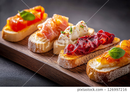 Colorful breakfast boards feature various toppings like cured meats, fruits, and spreads on toasted bread slices, ideal for sharing at a brunch gathering 126997216