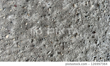Surface texture of concrete showing various stones and pebbles 126997364