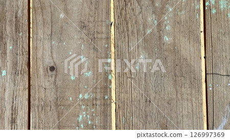 Weathered wooden floor with vibrant green accents and cracks Weathered wooden floor with vibrant green accents and cracks 126997369