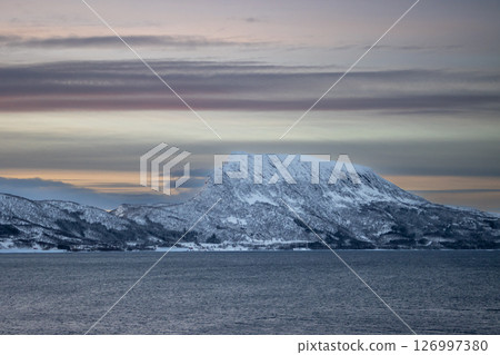 Sea and snowy mountains in the sunset, Norway 126997380