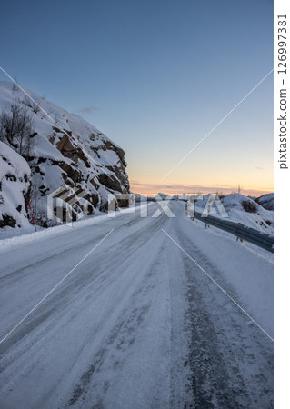 Snowy road up a hill, Norway 126997381