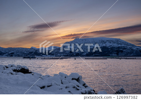 Sea and snowy mountains in the sunset, Norway Sea and snowy mountains in the sunset, Norway 126997382