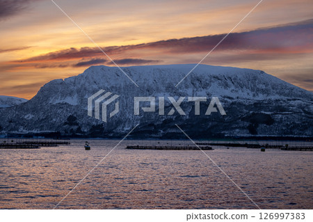 Sea and snowy mountains in the sunset, Norway 126997383