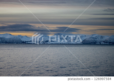 Sea and snowy mountains in the sunset, Norway 126997384