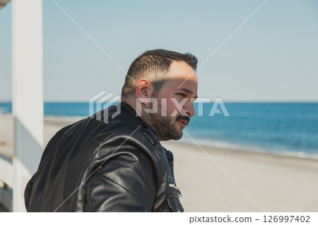 Man Relaxing At The Beach Resort Watching The Sea  126997402