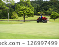 Golf course green and greenkeeper 126997499