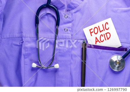 Folic acid symbol. Concept words Folic acid on beautiful white card. Stethoscope and pen. Beautiful medical uniform. Medical healthy lifestyle folic acid concept. 126997790