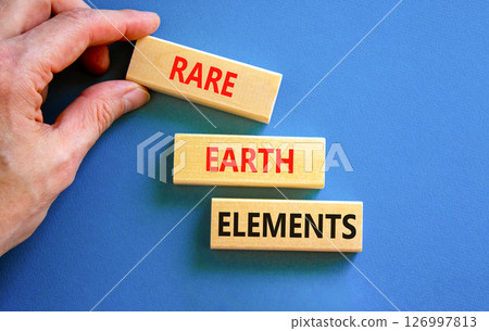 Rare earth elements symbol. Concept words Rare earth elements on beautiful wooden block. Businessman's hand. Beautiful blue background. Business and rare earth elements concept. Copy space. 126997813