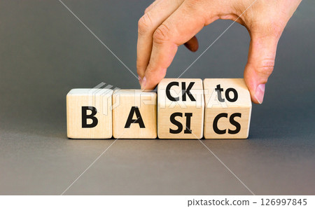 Back to basics symbol. Concept words Back to basics on wooden block. Beautiful grey table grey background. Businessman hand. Business back to basics concept. Copy space. 126997845