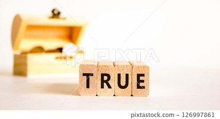 True symbol. Concept word True on beautiful wooden blocks. Beautiful wooden chest with coins. Beautiful white table white background. Business, lifestyle, support and true concept. Copy space. 126997861