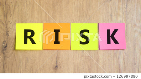 Risk symbol. Concept word Risk on beautiful colored paper. Beautiful wooden table wooden background. Business, lifestyle, support and risk concept. Copy space. Risk symbol. Concept word Risk on beautiful colored paper. Beautiful wooden table wooden background. Business, lifestyle, support and risk concept. Copy space. 126997880