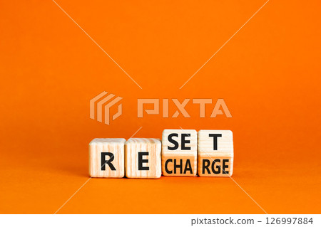 Reset and recharge symbol. Concept words Reset Recharge on beautiful wooden block. Beautiful orange table orange background. Business reset and recharge concept. Copy space. Reset and recharge symbol. Concept words Reset Recharge on beautiful wooden block. Beautiful orange table orange background. Business reset and recharge concept. Copy space. 126997884
