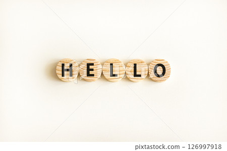 Hello symbol. Concept word Hello on beautiful wooden circles. Beautiful white table white background. Business lifestyle hello concept. Copy space. 126997918