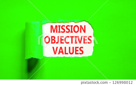 Mission objectives values symbol. Concept words Mission Objectives Values on beautiful white paper. Beautiful green table green background. Business mission objectives values concept. Copy space. 126998012