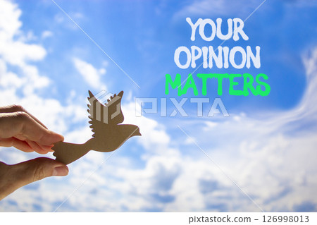 Your opinion matters symbol. Concept words Your opinion matters on beautiful blue sky. Beautiful blue sky and clouds background. Businessman hand. Business your opinion matters concept. Copy space. Your opinion matters symbol. Concept words Your opinion matters on beautiful blue sky. Beautiful blue sky and clouds background. Businessman hand. Business your opinion matters concept. Copy space. 126998013