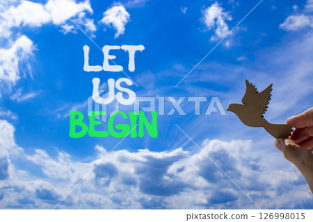 Let us begin symbol. Concept words Let us begin on beautiful blue sky. Beautiful blue sky and clouds background. Businessman hand. Wooden bird. Business motivational let us begin concept. Copy space. Let us begin symbol. Concept words Let us begin on beautiful blue sky. Beautiful blue sky and clouds background. Businessman hand. Wooden bird. Business motivational let us begin concept. Copy space. 126998015