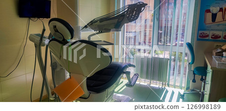 Modern dental clinic, dental chair and other accessories used by dentists. Concept of pediatric dentistry, treatment of oral diseases. 126998189