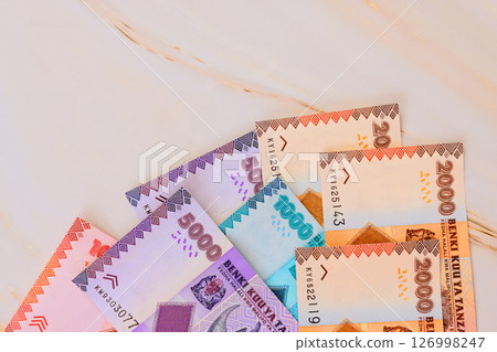 Tanzanian shilling banknotes currency notes of various denominations are spread out on marble surface 126998247