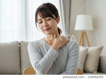Close-up of a woman suffering from stiff shoulders (AI-generated image) 126998305