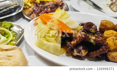 Polvo a Lagareiro, Grilled Octopus with boiled potatoes, in a Restaurant in Porto, Portugal 126998371