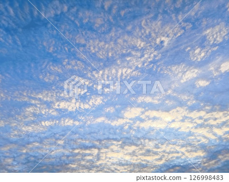white clouds, thick clouds like sea waves. abstract blue sky background with thick clouds. white clouds, thick clouds like sea waves. abstract blue sky background with thick clouds. 126998483