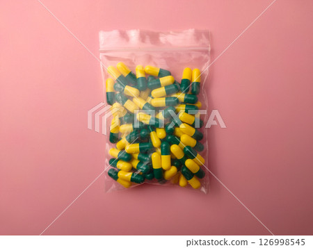 Top view of a medicine pill package on a pink background. 126998545