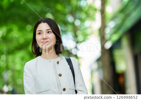 A woman commuting in a business district 126998652