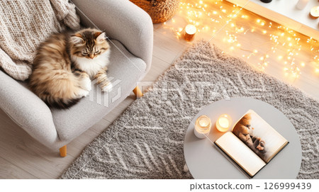Kitten in cozy modern living room with candles and books, perfect for relaxation background 126999439