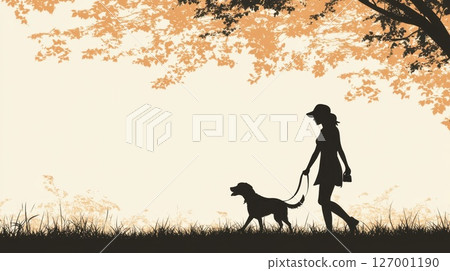 Silhouette of a woman walking her dog in a park during sunset 127001190