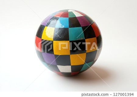 Colorful handcrafted sphere with geometric patterns displayed against a neutral background 127001394