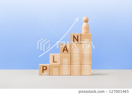 Wooden cubes with the words plan, white arrow and wooden man are a symbol of success, business progress, strategic development of a company, startup. Business concept Wooden cubes with the words plan, white arrow and wooden man are a symbol of success, business progress, strategic development of a company, startup. Business concept 127001465