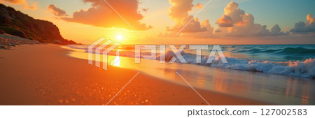 Golden sunset over calm beach waves. 127002583
