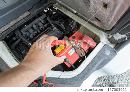 A light truck with an engine compartment under the passenger seat - Charging the battery 127003011