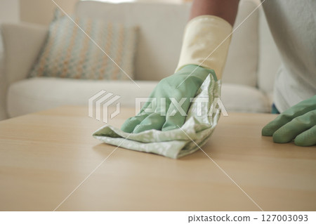 Cleaning process in a bright living room with caution 127003093