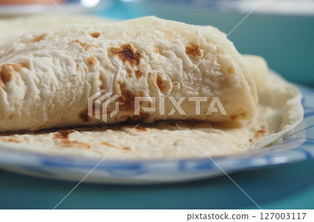 Freshly cooked tortillas on a plate ready to be enjoyed Freshly cooked tortillas on a plate ready to be enjoyed 127003117