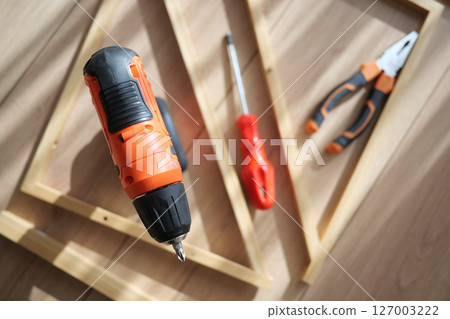 Tools arranged for a woodworking project in natural light 127003222