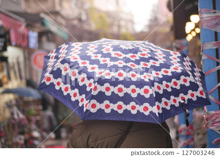 Colorful umbrella adds charm to busy street market Colorful umbrella adds charm to busy street market 127003246