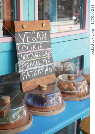 Delicious vegan treats displayed at a colorful cafe 127003281