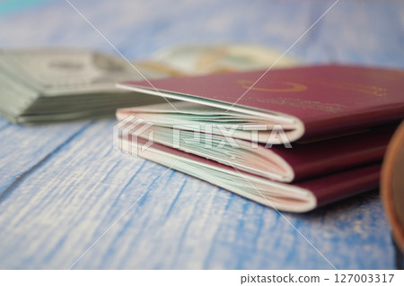 Travel preparations with passports and cash on a table Travel preparations with passports and cash on a table 127003317