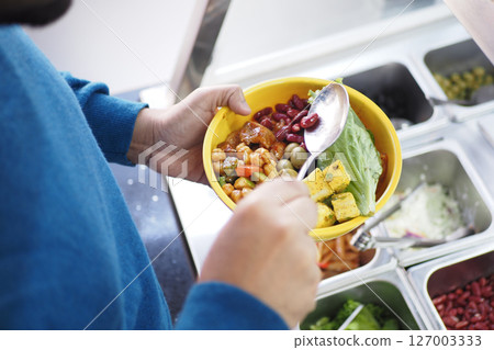 Healthy meal preparation at a cafeteria buffet line 127003333