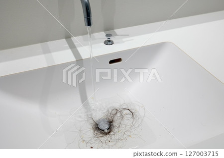 Hair in the bathroom sink drain 127003715