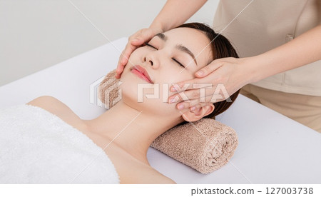 Young Japanese woman receiving face massage treatment Young Japanese woman receiving face massage treatment 127003738