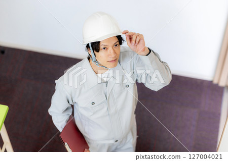 Construction worker climbing stairs Construction worker climbing stairs 127004021