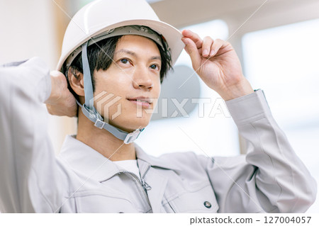 A construction manager wearing a helmet 127004057