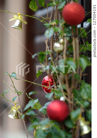 View of Christmas decoration hanging on door of restaurant on the street of the Old Bar Town in Montenegro 127004191