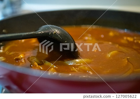 Cooking curry in a frying pan 127005622