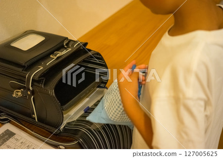 Elementary school students preparing for tomorrow's school before going to bed 127005625