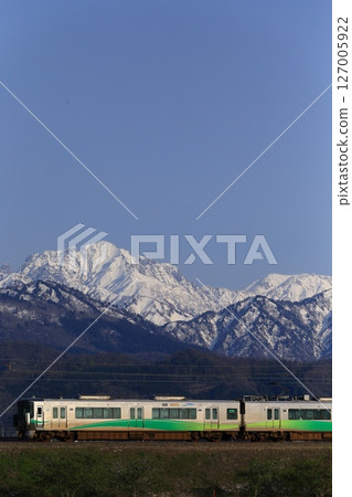 Ainokaze Toyama Railway's 521 series train running with the Tateyama mountain range in the background Ainokaze Toyama Railway's 521 series train running with the Tateyama mountain range in the background 127005922