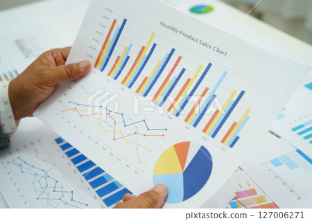 Asian business woman working with financial graph. 127006271