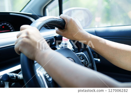 Asian woman driver holding water bottle in car. Asian woman driver holding water bottle in car. 127006282